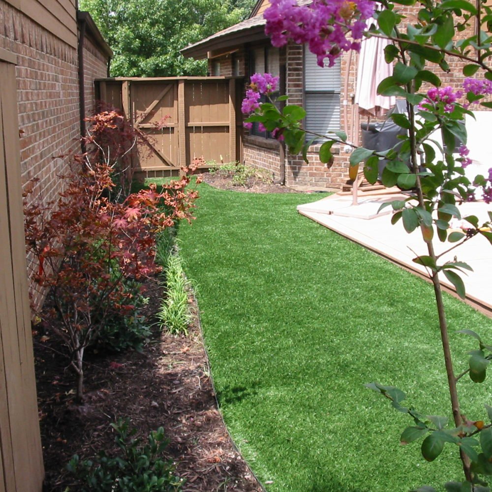 Crew installing sod and planting beds in front yard of updated Dallas home